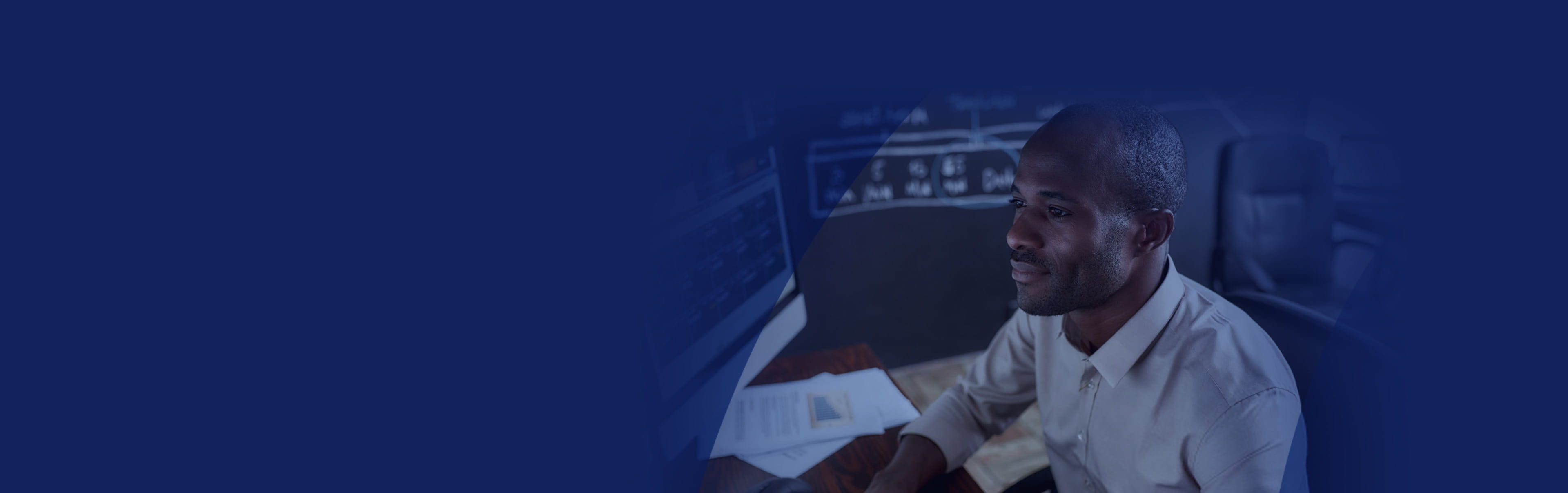 Man looking at financial data on monitor